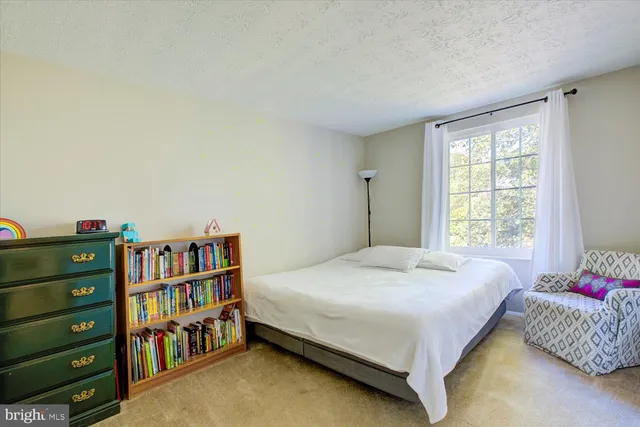 a bedroom with a bed and a book shelf