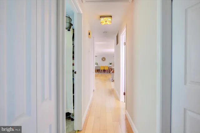 a view of a hallway with wooden floor