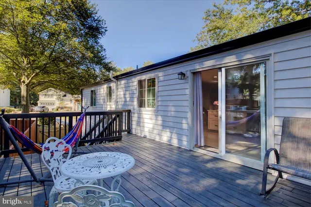 an outdoor space with wooden floor and outdoor seating