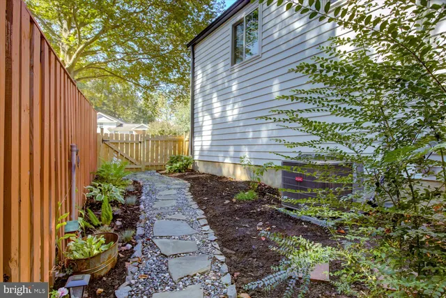 a view of a pathway with a garden