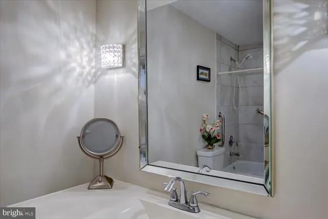 a bathroom with a sink a mirror and vanity
