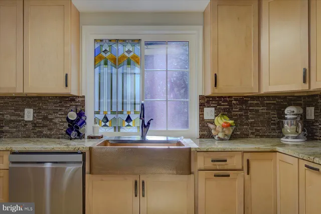 a kitchen with stainless steel appliances granite countertop a sink and a microwave