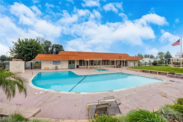an aerial view of a house with swimming pool garden and lake view