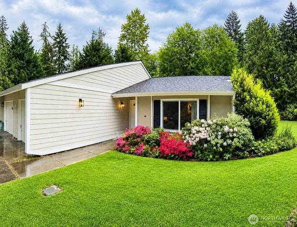a front view of a house with a garden
