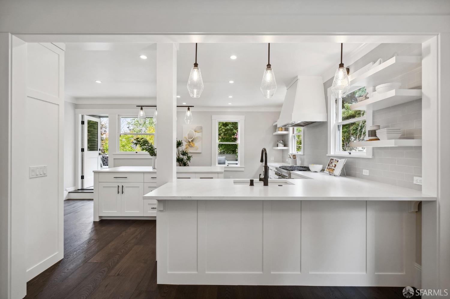 2518 Etna Street Berkeley, CA 94704 - Photo 18 of 99 a kitchen with kitchen island granite countertop a sink cabinets and wooden floor