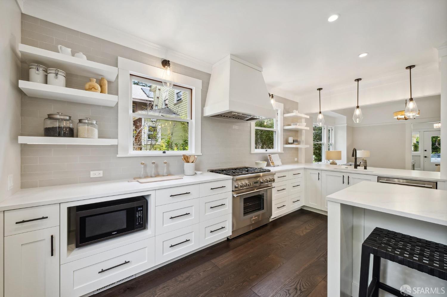 2518 Etna Street Berkeley, CA 94704 - Photo 22 of 99 a kitchen with white cabinets and white appliances