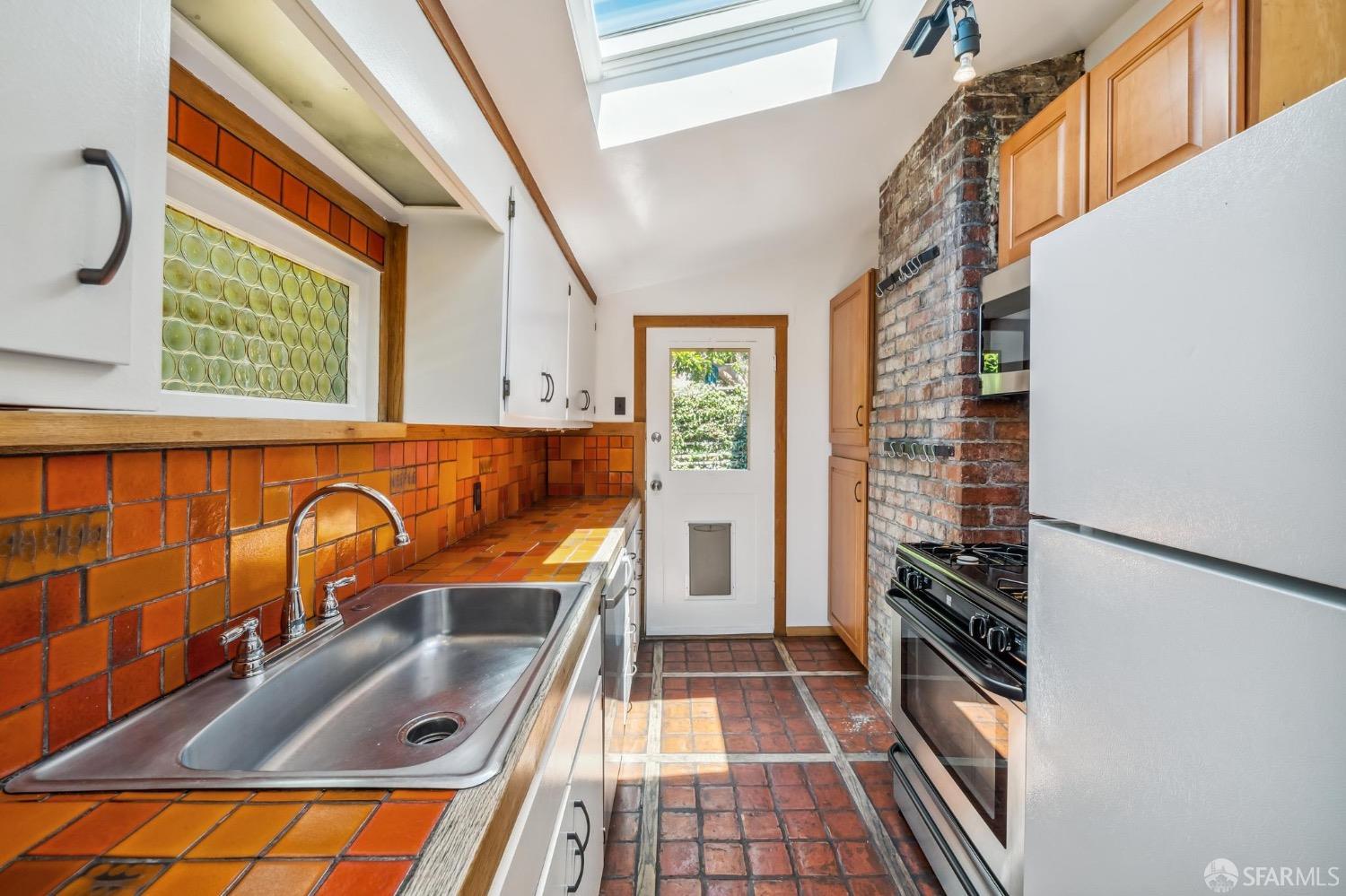 2518 Etna Street Berkeley, CA 94704 - Photo 73 of 99 a kitchen with granite countertop a stove and a sink
