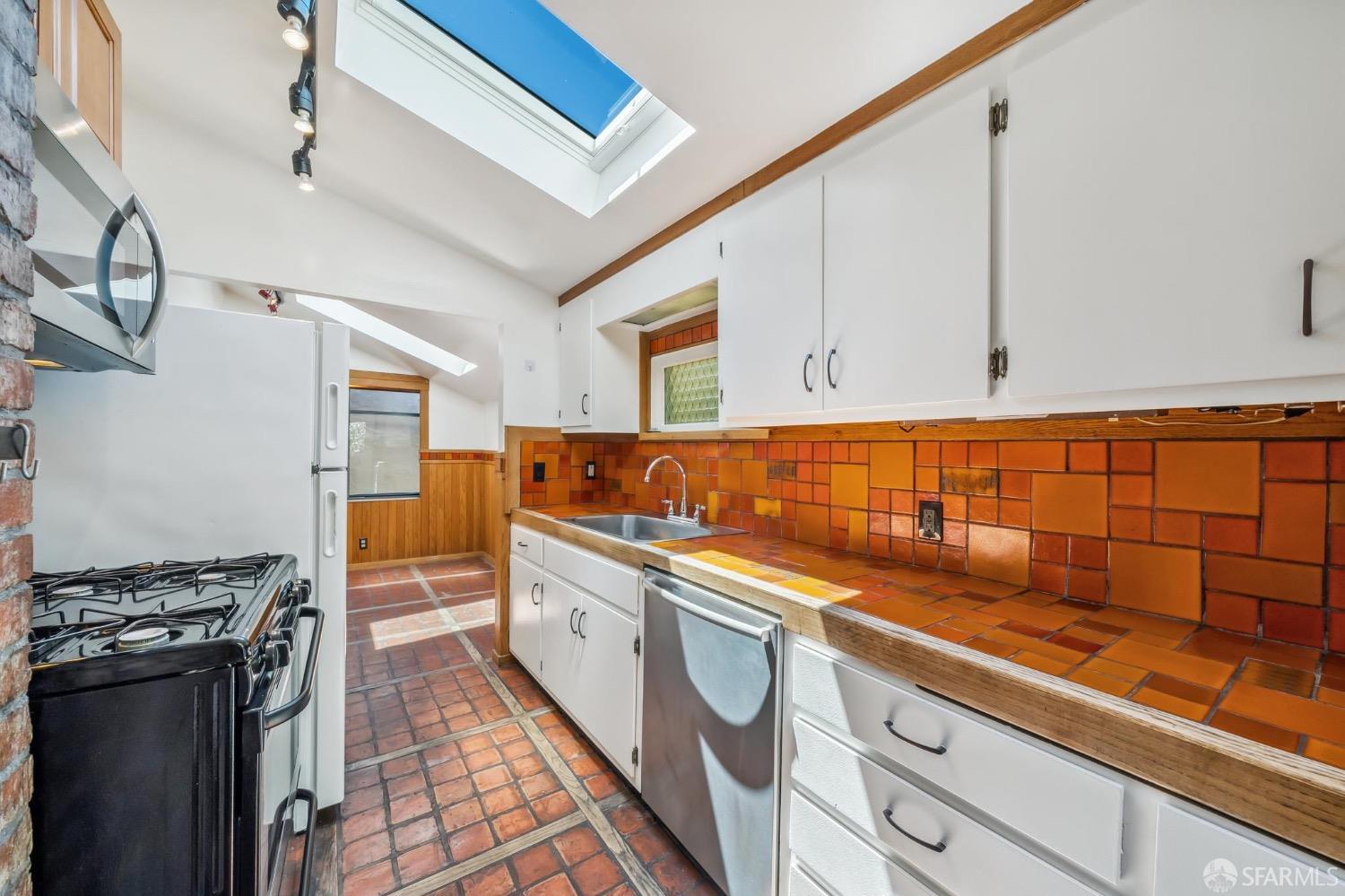 2518 Etna Street Berkeley, CA 94704 - Photo 74 of 99 a kitchen with stainless steel appliances granite countertop a sink and cabinets