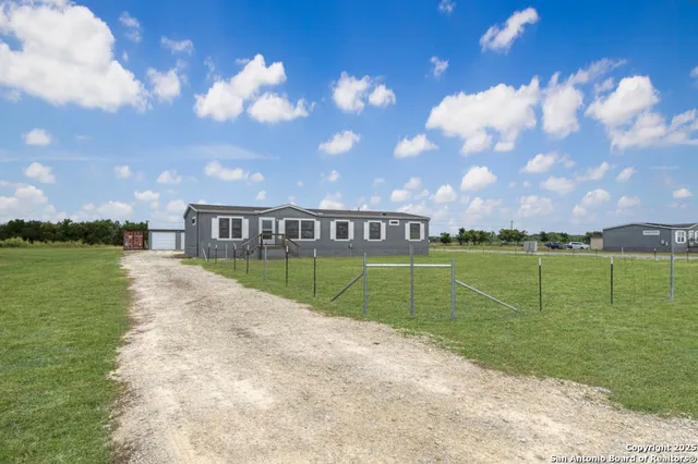 a view of swimming pool is middle in the garden