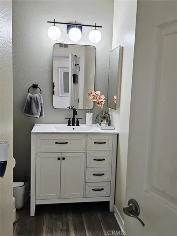 a bathroom with a sink vanity and mirror