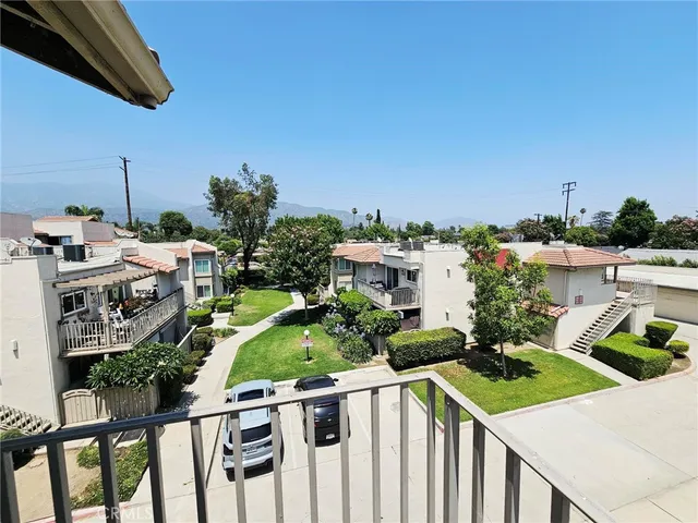 a view of a house with backyard and seating area