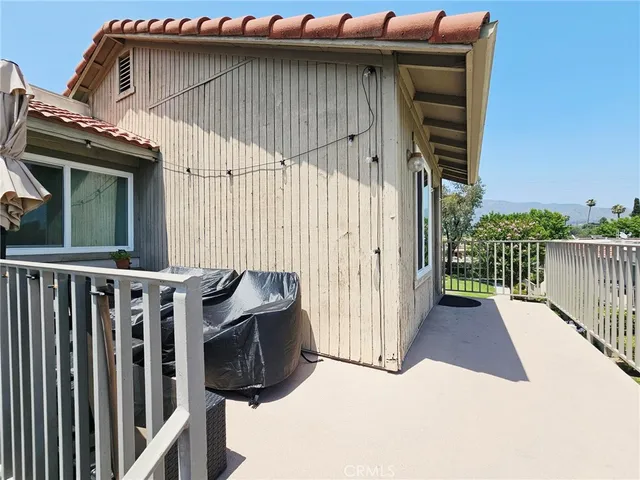 a view of a small house with wooden fence