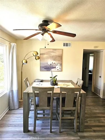 a view of a dining room with furniture and wooden floor