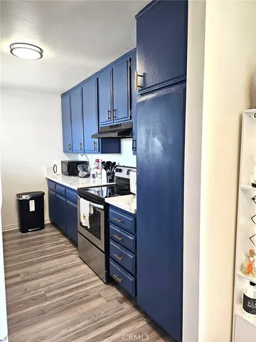 a kitchen with stainless steel appliances granite countertop a refrigerator and a stove