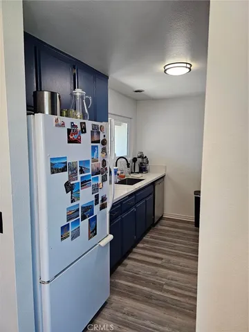 a kitchen with stainless steel appliances a refrigerator and wooden cabinets