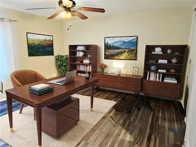 a workspace with wooden floor and a bookshelf