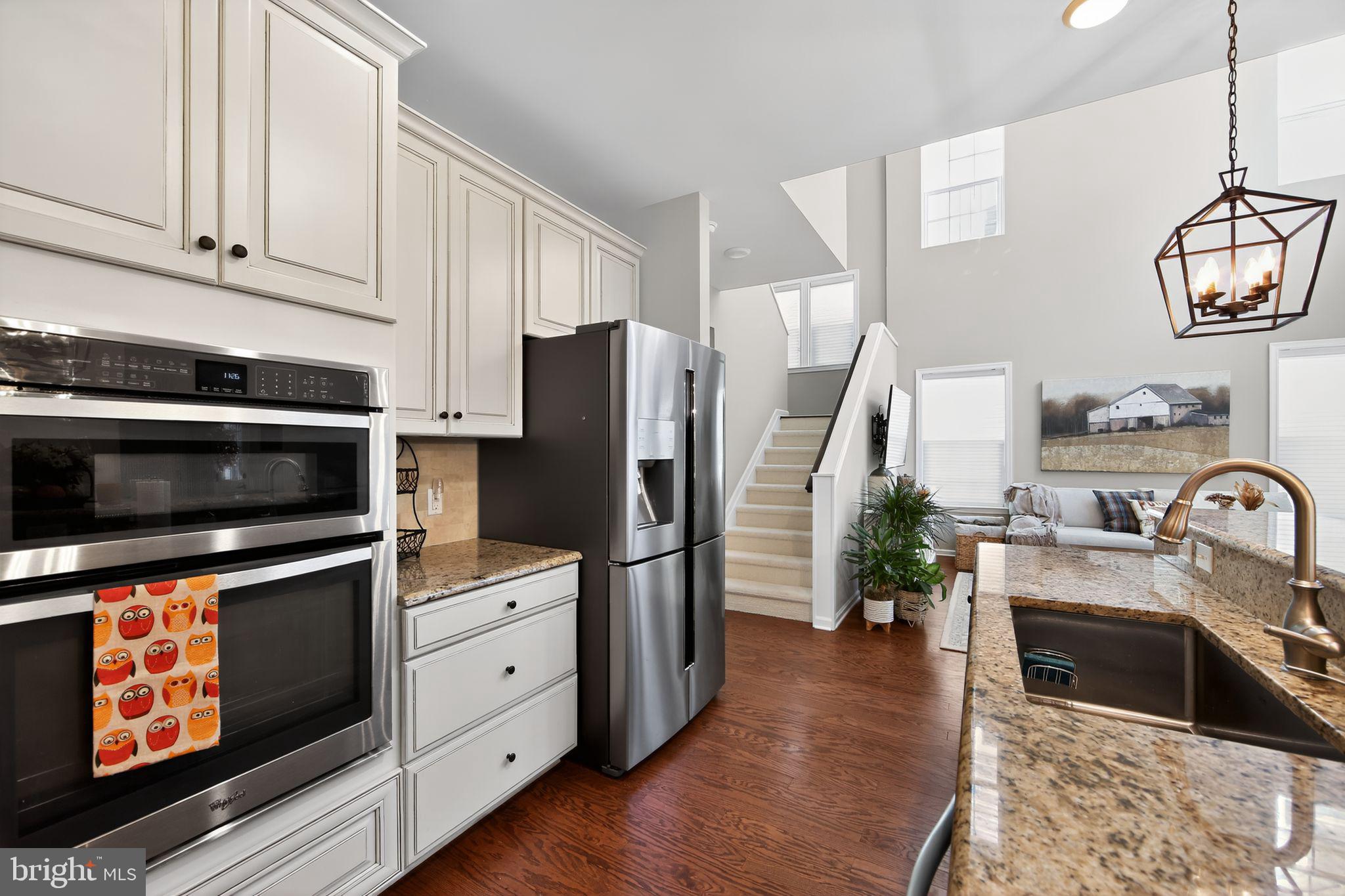 618 Kent Court Chester Springs, PA 19425 - Photo 11 of 34 a kitchen with stainless steel appliances granite countertop a refrigerator a stove and a sink with wooden floor
