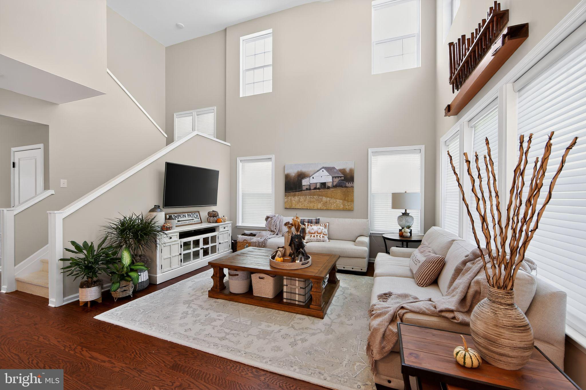 618 Kent Court Chester Springs, PA 19425 - Photo 6 of 34 a living room with furniture a flat screen tv and a potted plant