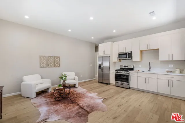 a kitchen with a sink stainless steel appliances and cabinets