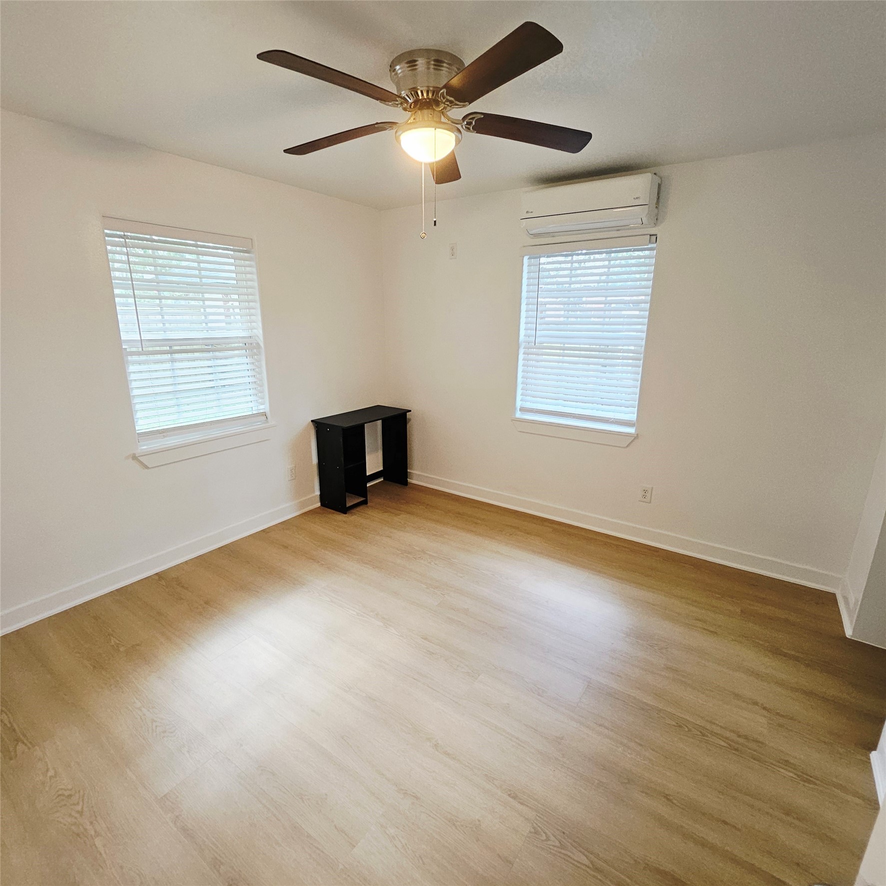 305 Miles Road Bacliff, TX 77518 - Photo 12 of 17 a view of an empty room with a window and wooden floor