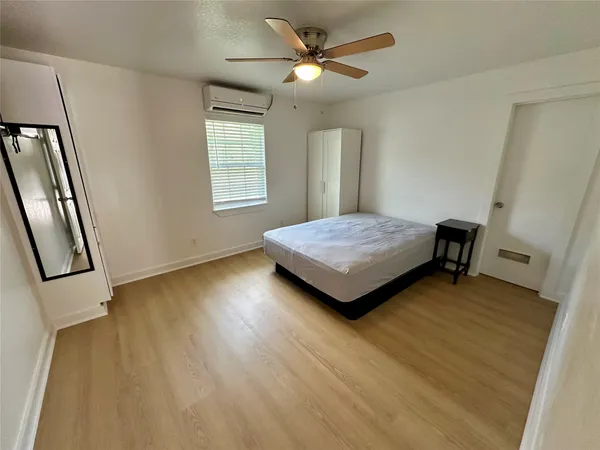 a living room with furniture and a mirror
