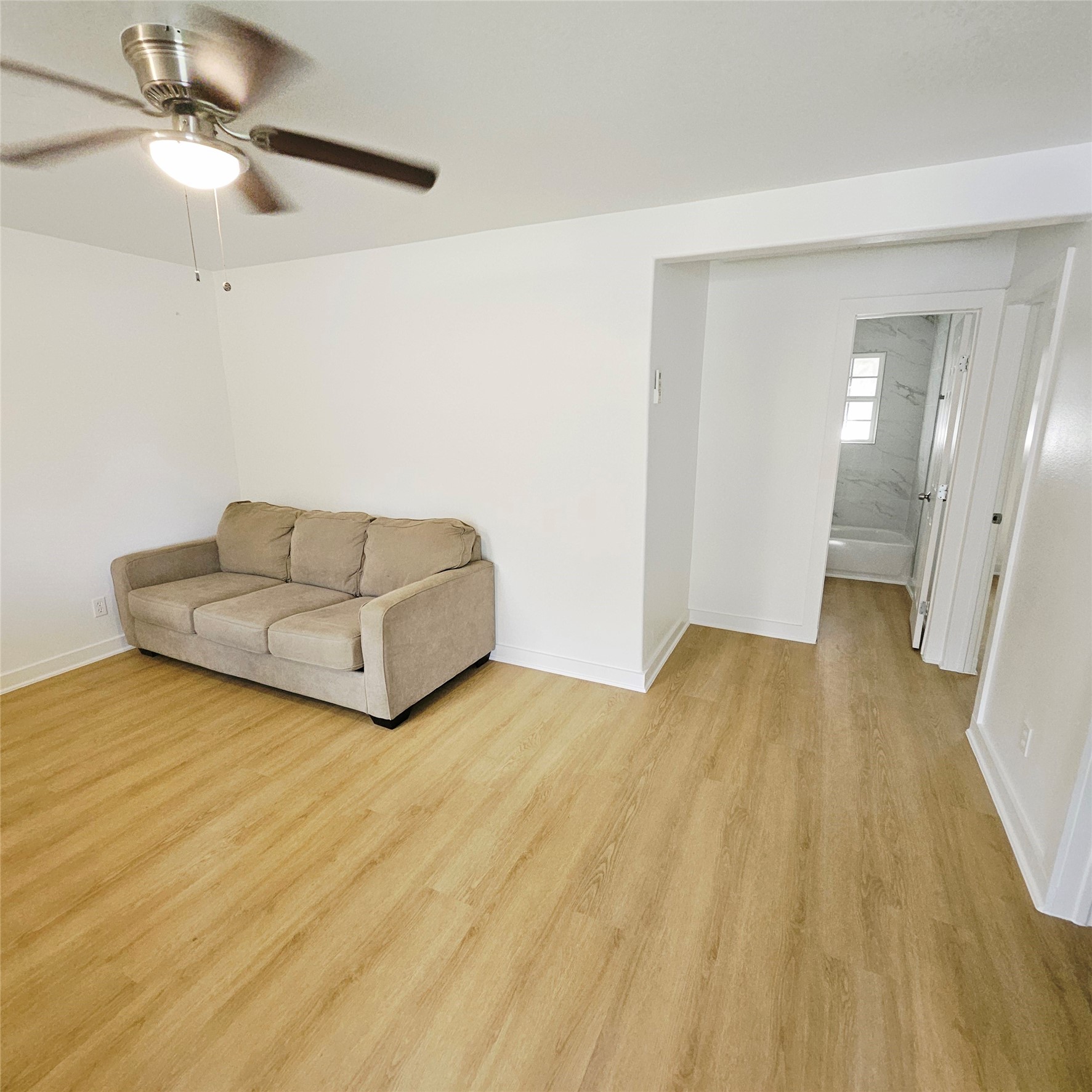 305 Miles Road Bacliff, TX 77518 - Photo 8 of 17 a living room with couch and a ceiling fan