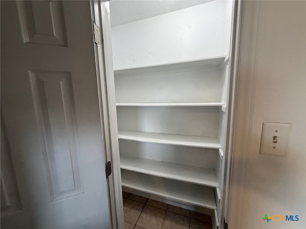 404 Blayton Street Troy, TX 76579 - Photo 11 of 30 a view of walk in closet with empty racks
