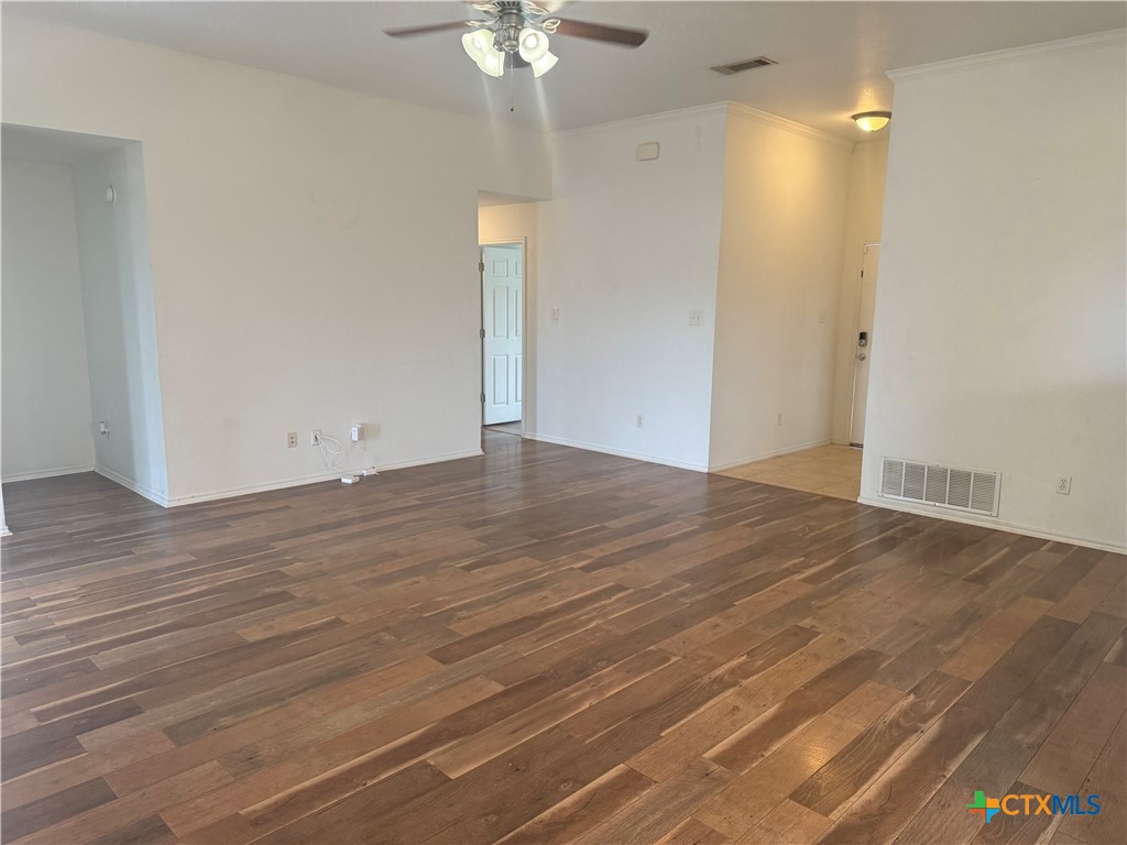 404 Blayton Street Troy, TX 76579 - Photo 19 of 30 an empty room with wooden floor and fan