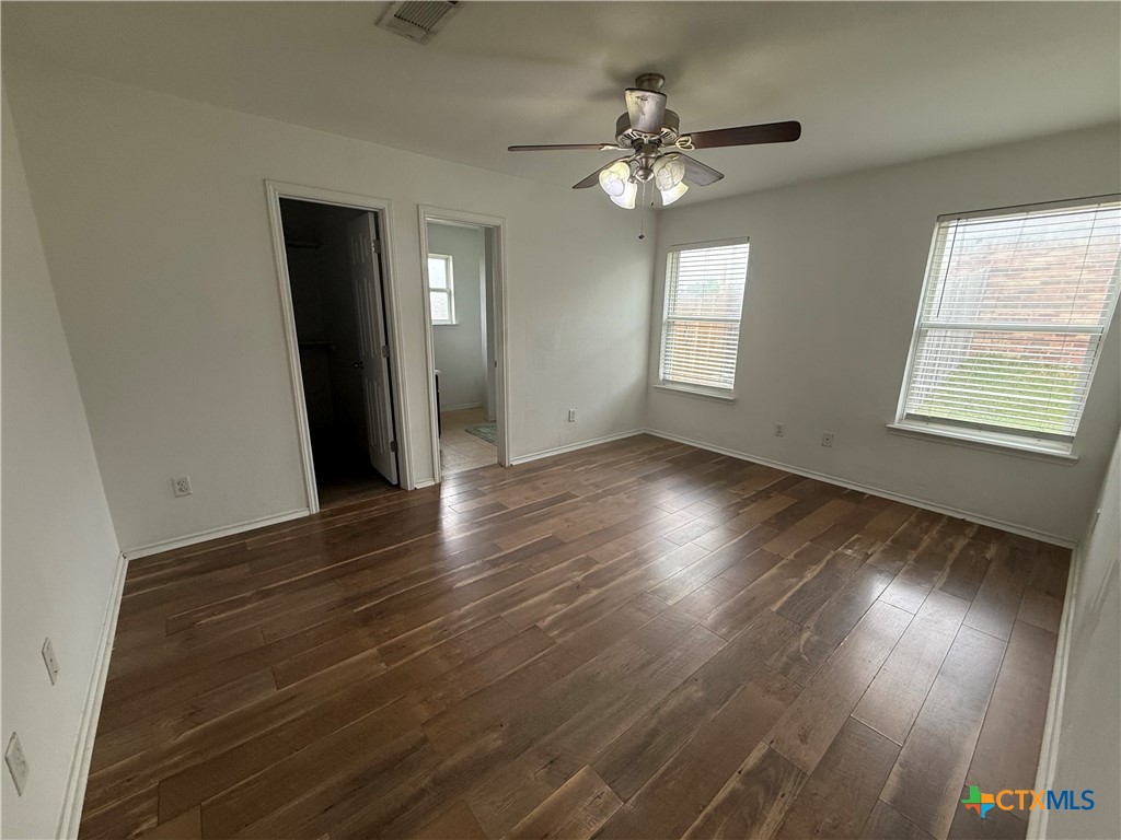 404 Blayton Street Troy, TX 76579 - Photo 20 of 30 a view of an empty room with wooden floor and a window