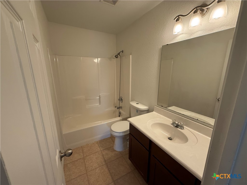 404 Blayton Street Troy, TX 76579 - Photo 26 of 30 a bathroom with a sink a toilet and shower