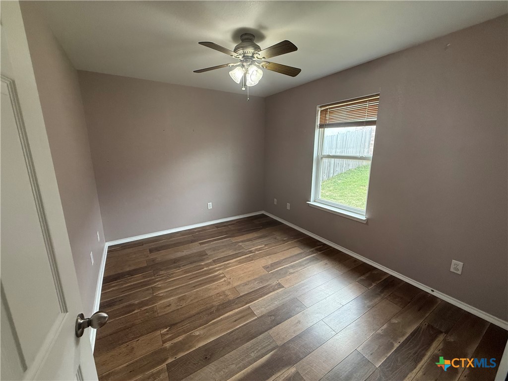 404 Blayton Street Troy, TX 76579 - Photo 27 of 30 wooden floor in an empty room with a window