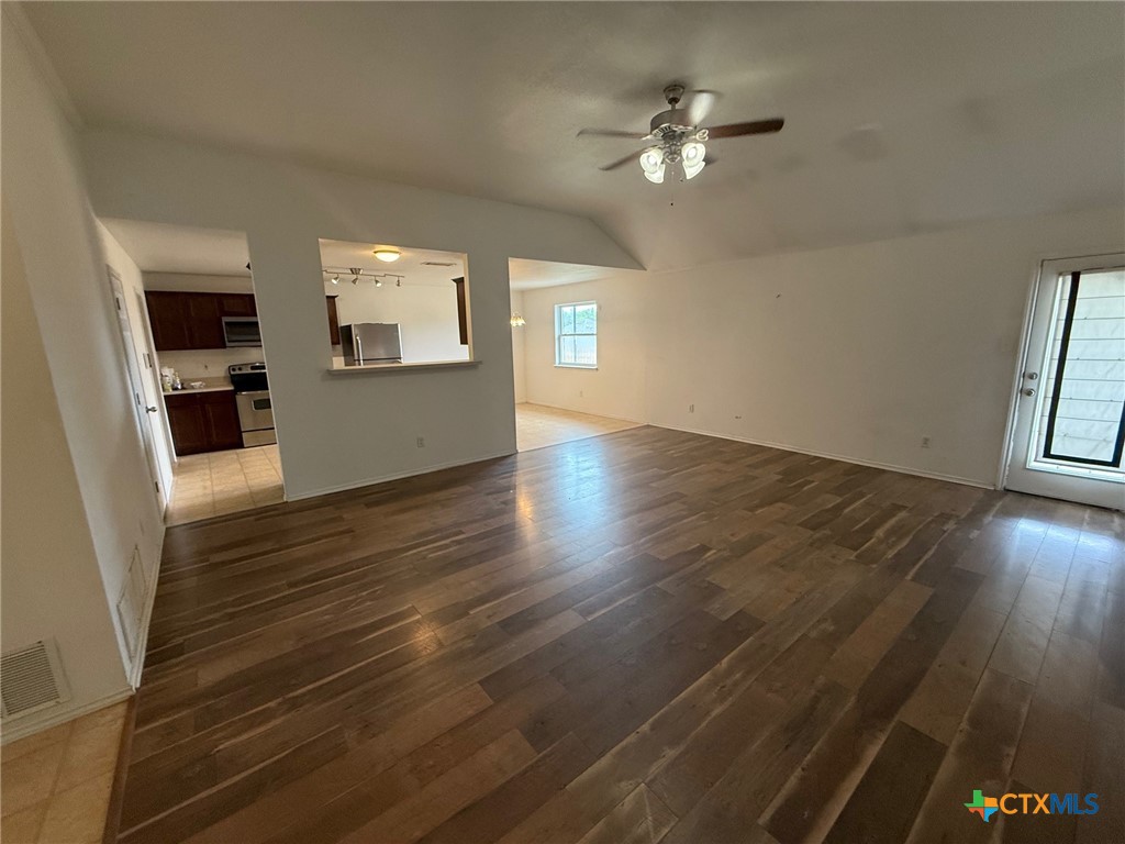 404 Blayton Street Troy, TX 76579 - Photo 6 of 30 wooden floor in an empty room with a window