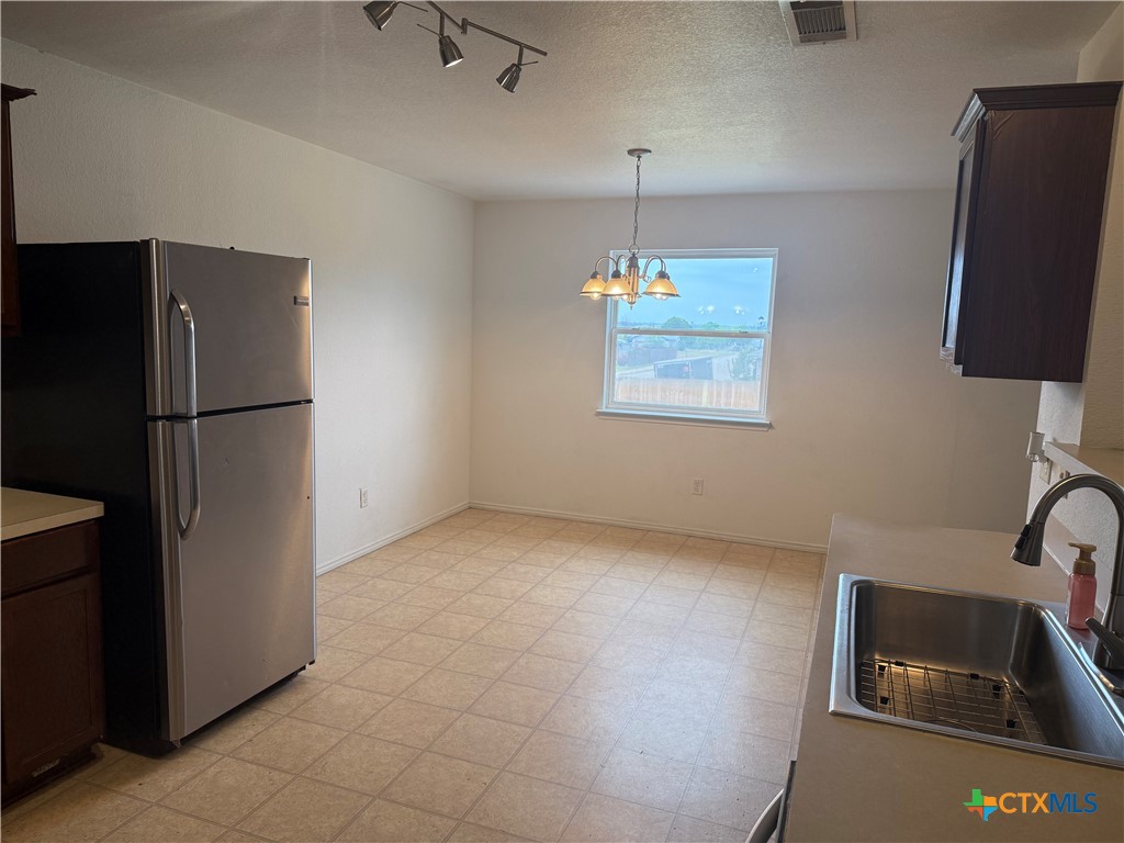 404 Blayton Street Troy, TX 76579 - Photo 9 of 30 a view of a kitchen with a sink refrigerator and window