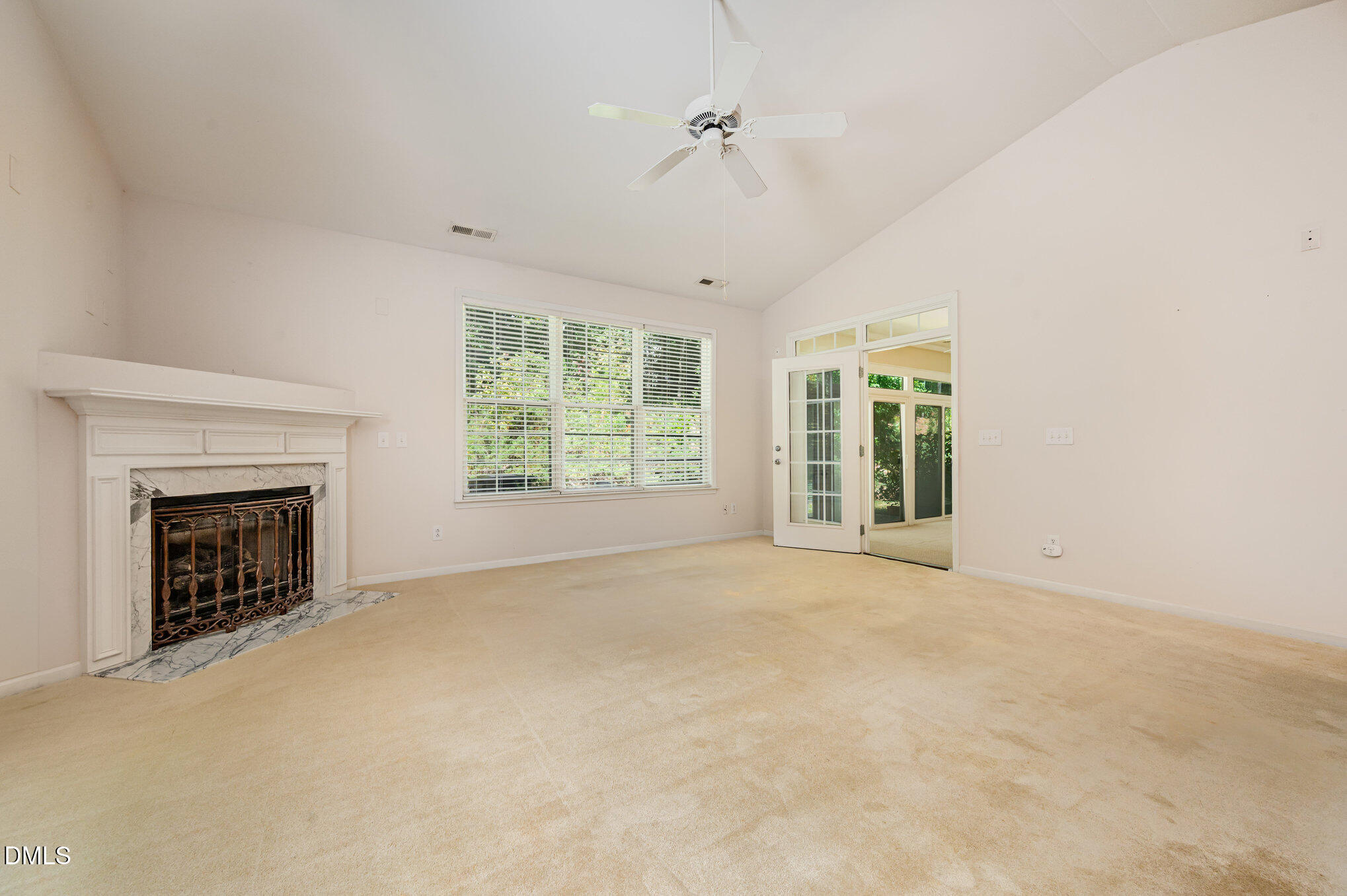 10441 Blue Dun Way Raleigh, NC 27614 - Photo 14 of 23 a view of an empty room with a fireplace and a window