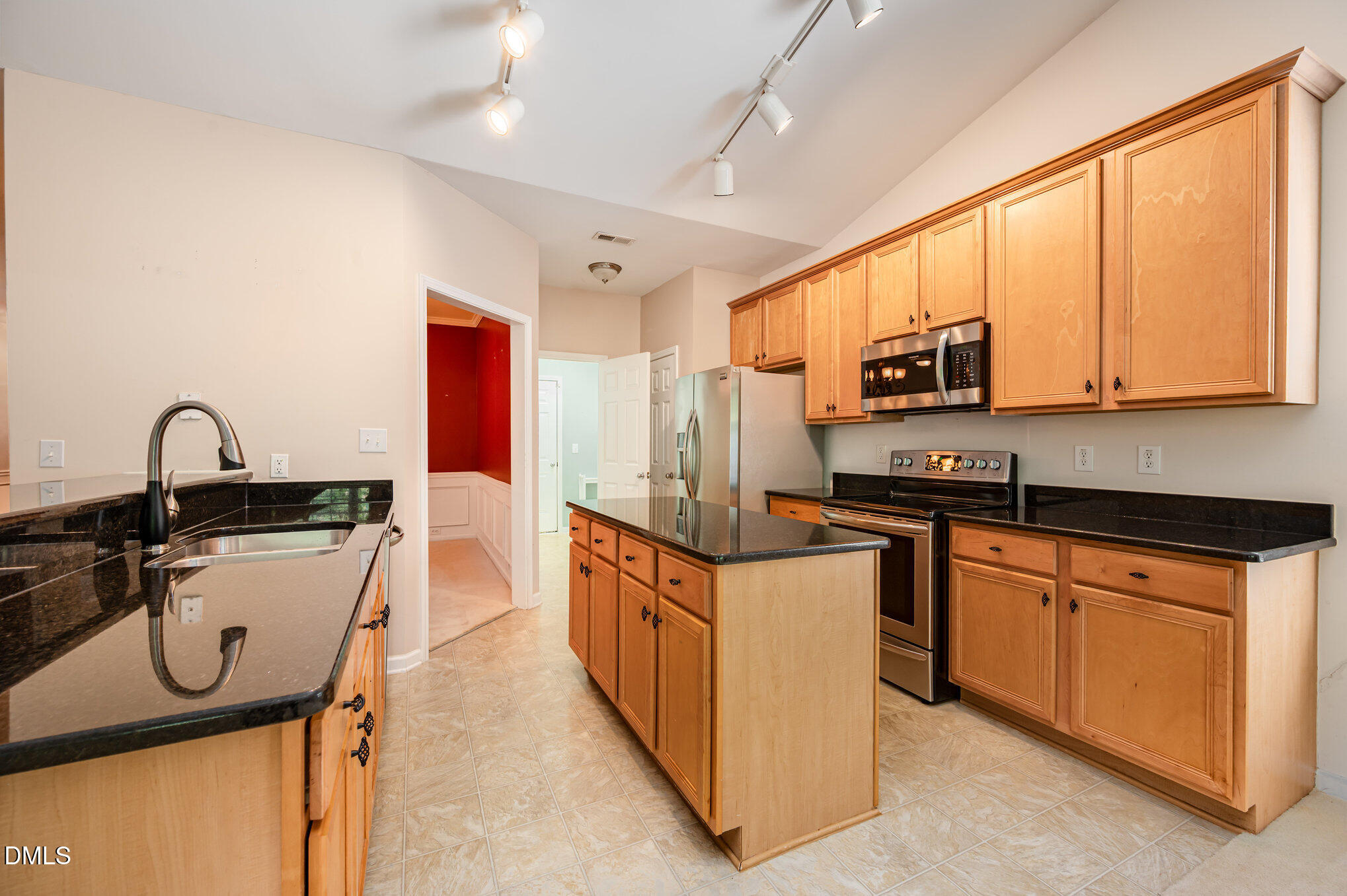 10441 Blue Dun Way Raleigh, NC 27614 - Photo 7 of 23 a kitchen with stainless steel appliances granite countertop a stove a sink and a microwave