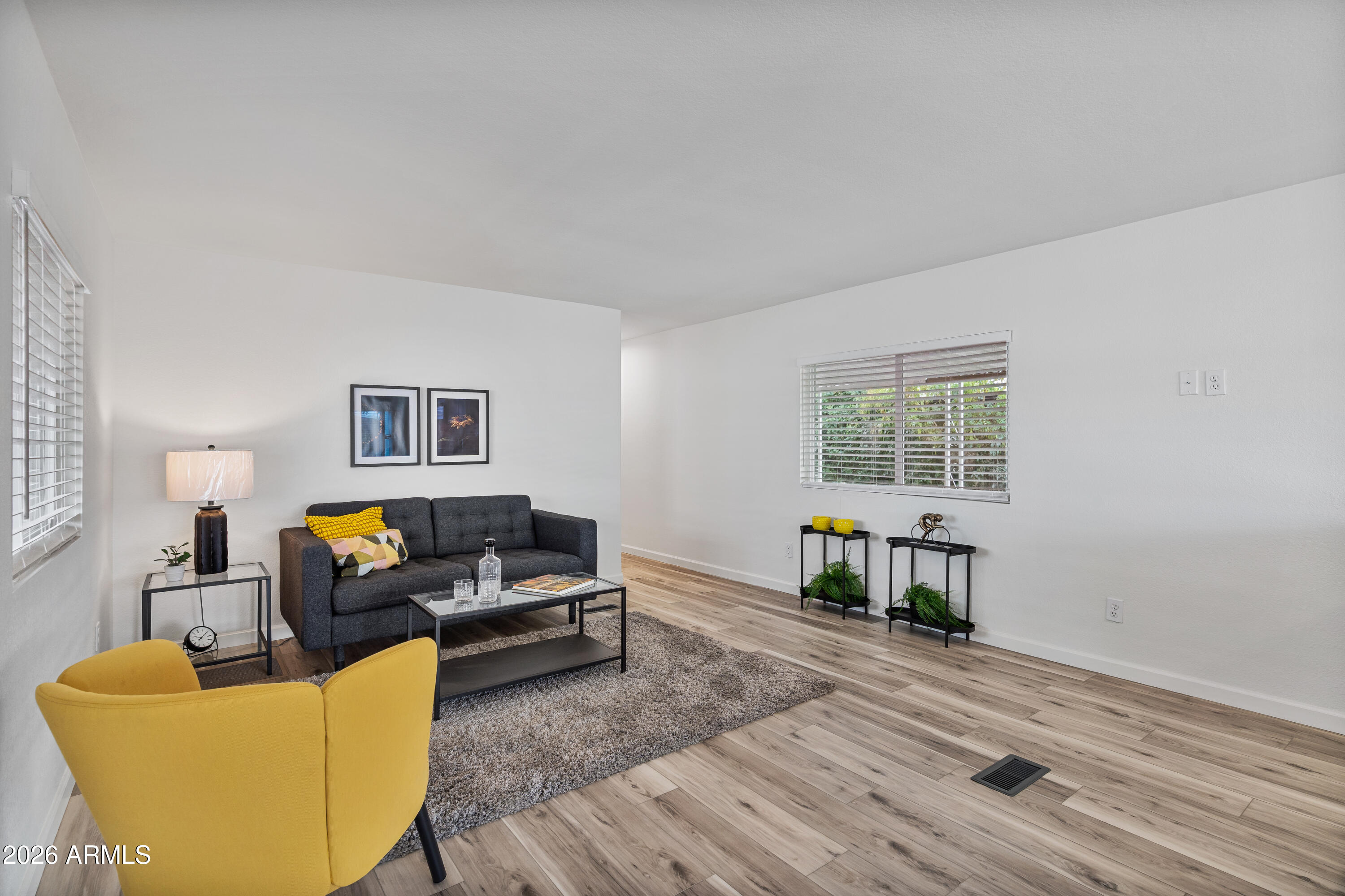 205 South Higley Road, Unit 52 Mesa, AZ 85206 - Photo 11 of 34 a living room with furniture and a wooden floor