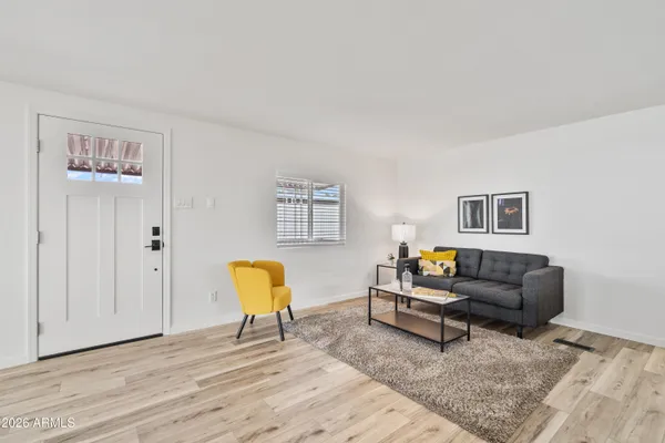 a living room with furniture and wooden floor