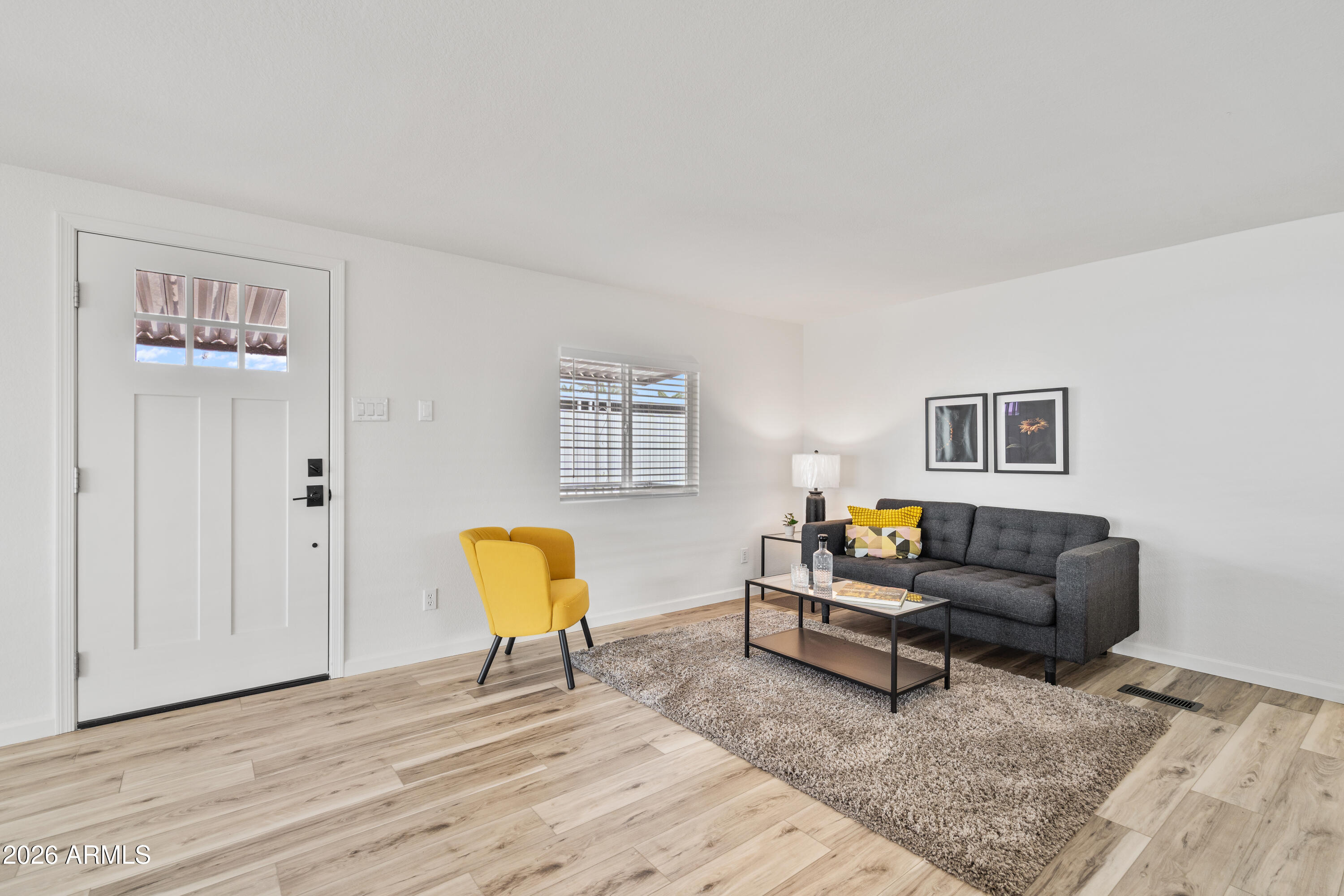 205 South Higley Road, Unit 52 Mesa, AZ 85206 - Photo 12 of 34 a living room with furniture and a wooden floor