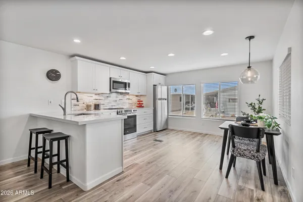 a kitchen with a refrigerator and cabinets