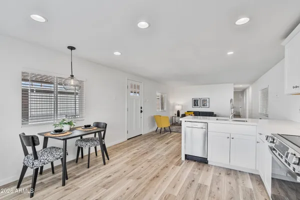 a kitchen with stainless steel appliances granite countertop white cabinets and a stove a oven with white countertops