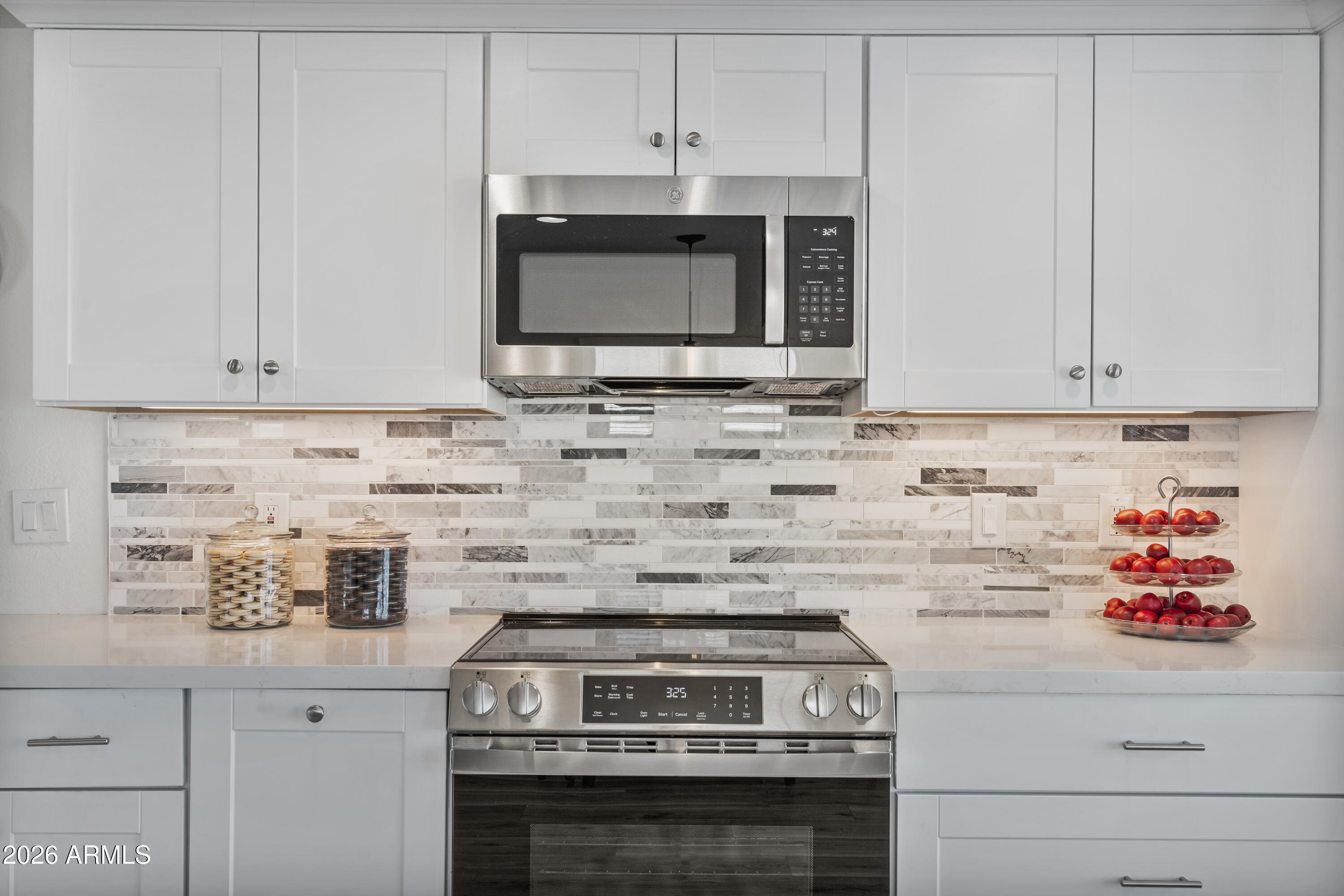 205 South Higley Road, Unit 52 Mesa, AZ 85206 - Photo 18 of 34 a kitchen with stainless steel appliances granite countertop white cabinets and a stove a oven with white countertops