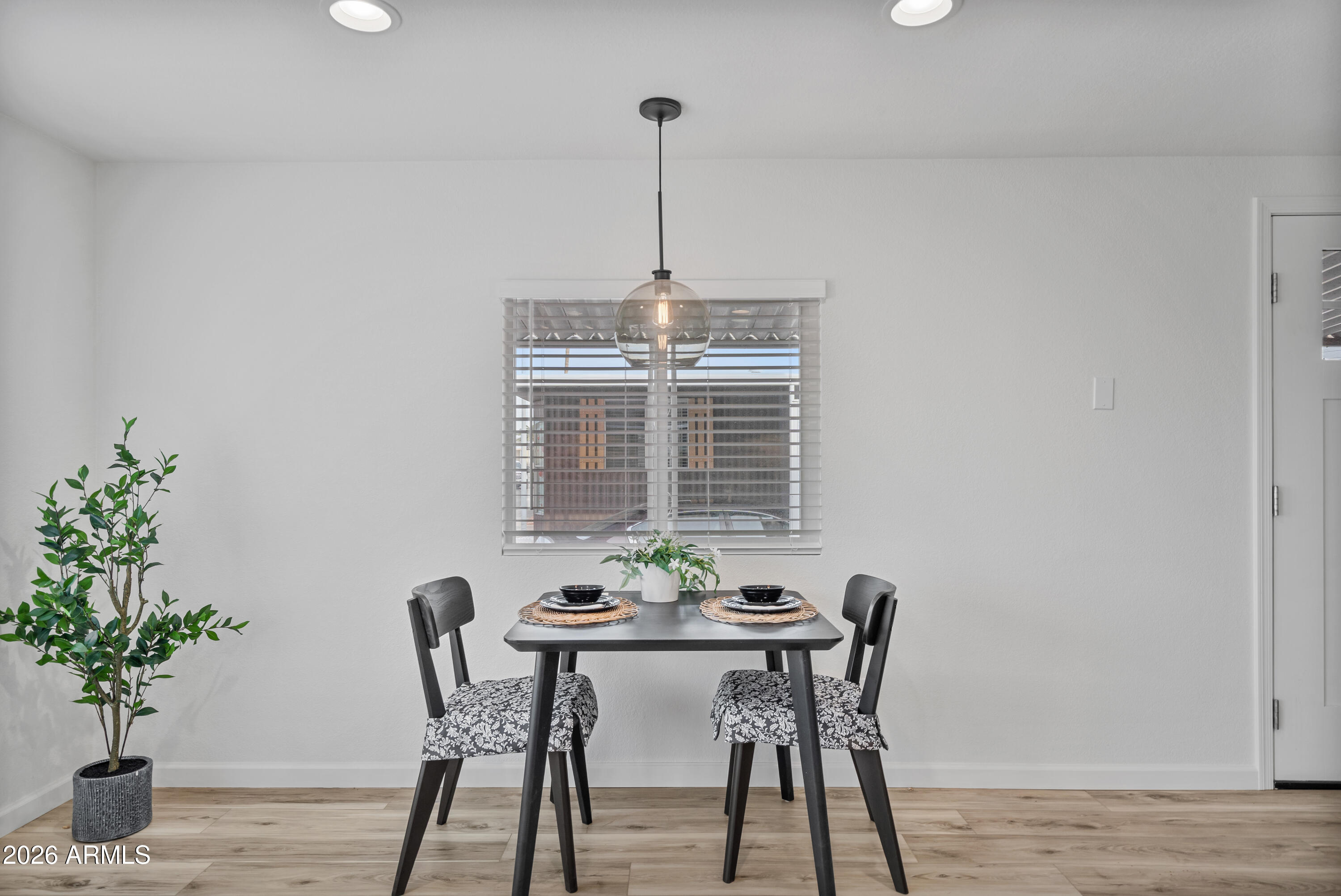 205 South Higley Road, Unit 52 Mesa, AZ 85206 - Photo 20 of 34 a view of a dining room with furniture window and wooden floor