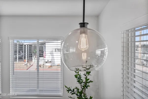 a bedroom with a bed and chandelier