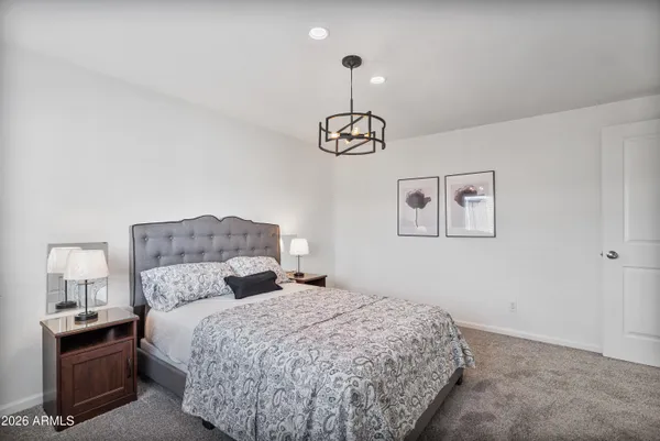 a bedroom with a large bed and a couch