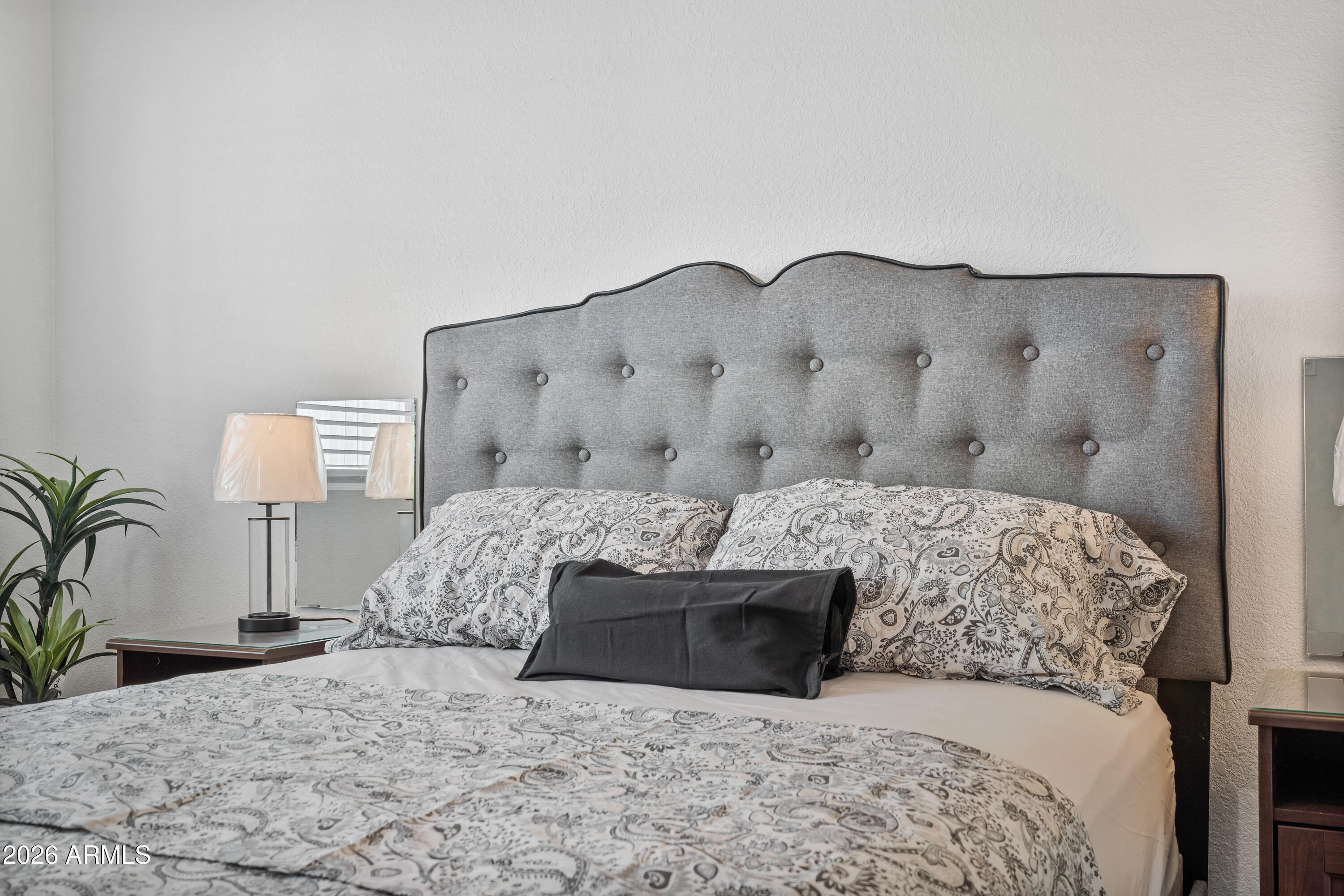 205 South Higley Road, Unit 52 Mesa, AZ 85206 - Photo 24 of 34 a bedroom with a large bed and a couch