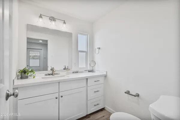 a bathroom with a shower sink and mirror