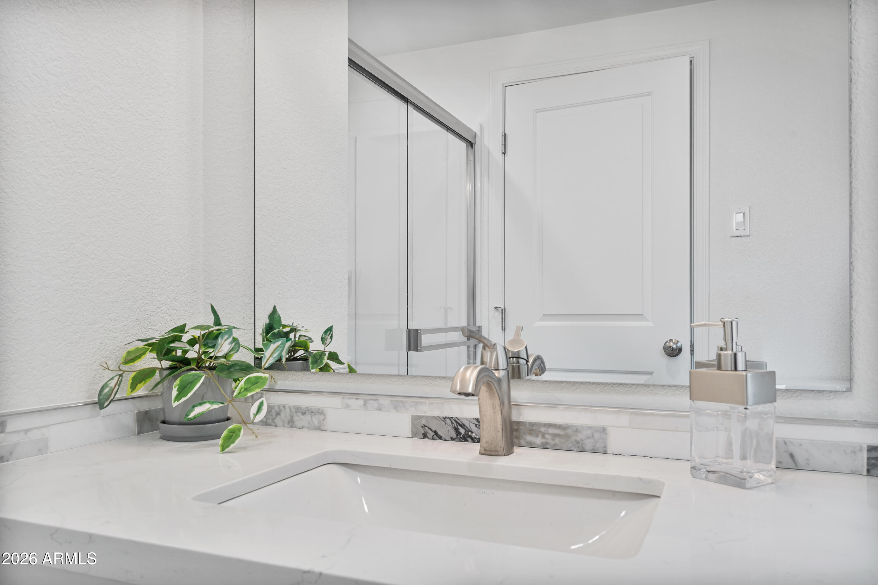 205 South Higley Road, Unit 52 Mesa, AZ 85206 - Photo 26 of 34 a bathroom with a granite countertop sink and a mirror