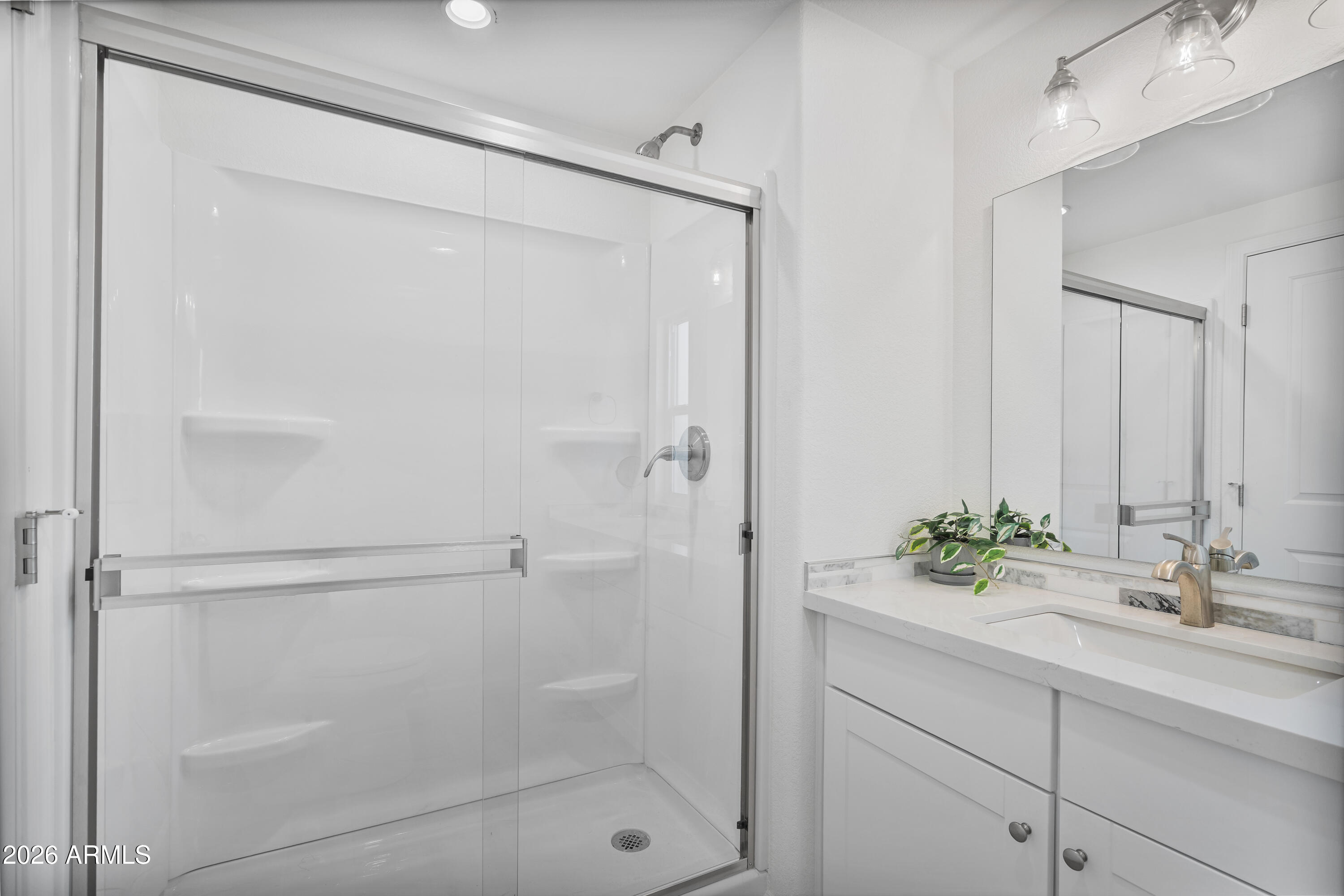 205 South Higley Road, Unit 52 Mesa, AZ 85206 - Photo 27 of 34 a bathroom with a shower sink and mirror