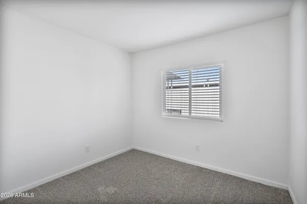 a view of a hallway with closet and wooden floor