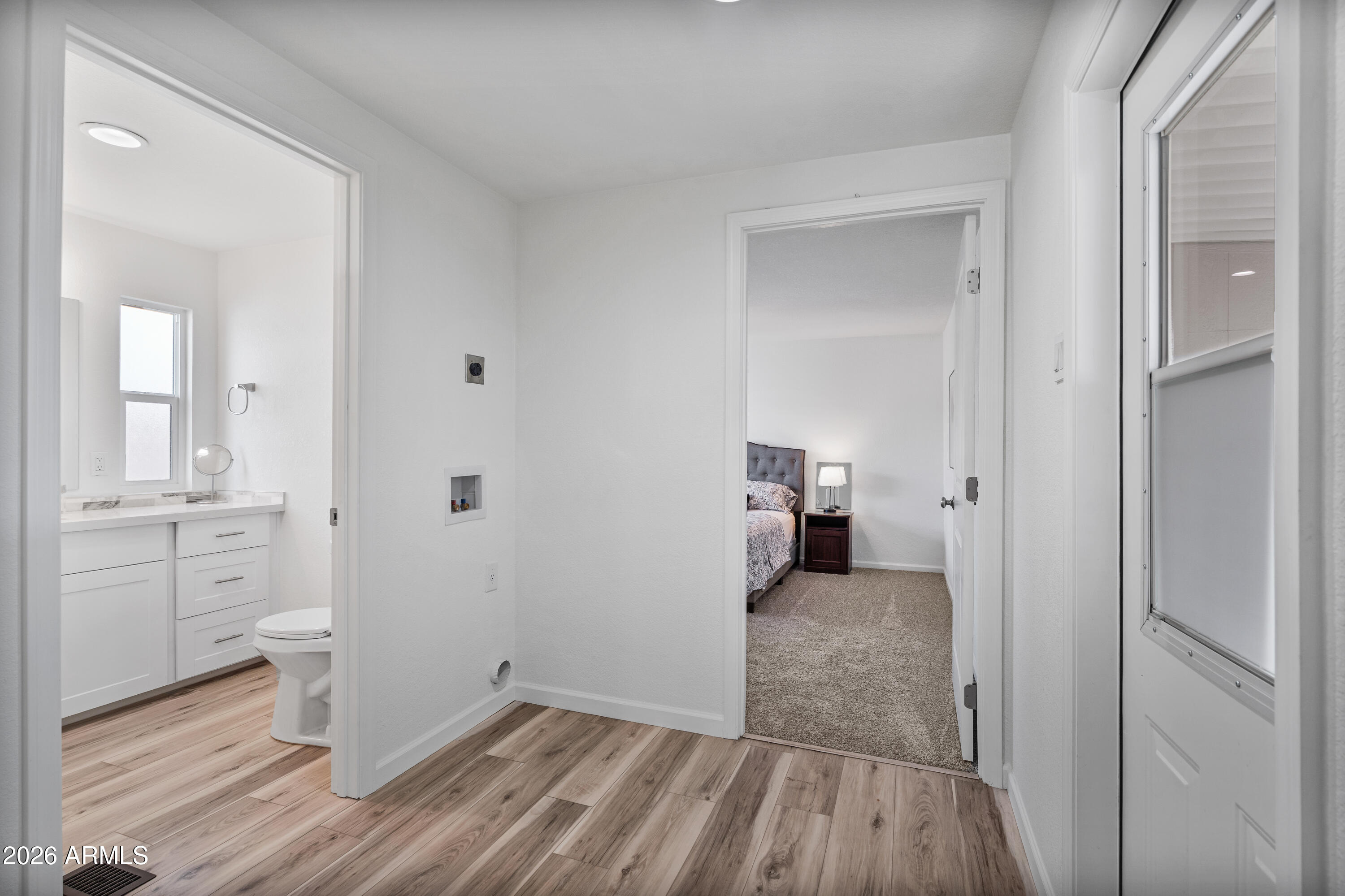 205 South Higley Road, Unit 52 Mesa, AZ 85206 - Photo 30 of 34 a view of a hallway with closet and wooden floor